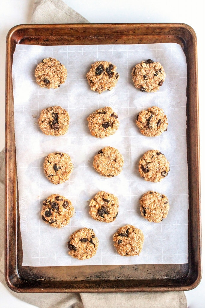 Oatmeal Coconut Cookies on a cookie sheet with parchment paper