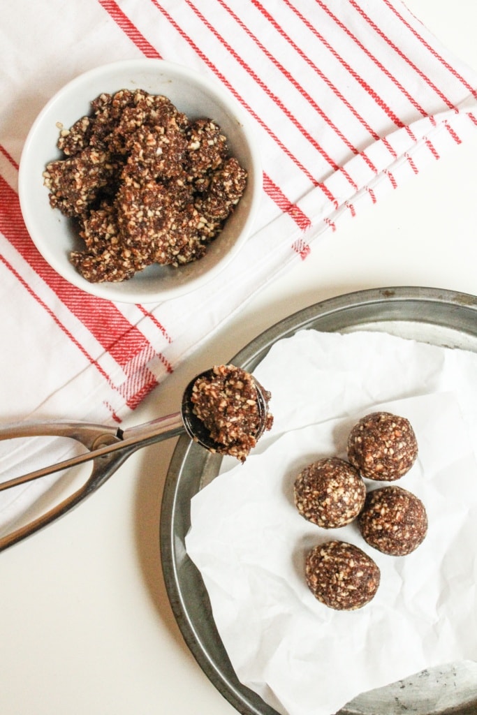 scooping almond bites mixture into balls