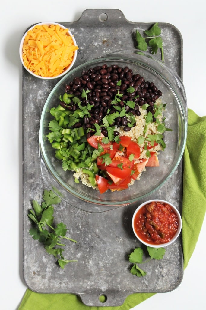 bowl with black beans, shredded cheese, salsa, bell peppers, quinoa, and cilantro