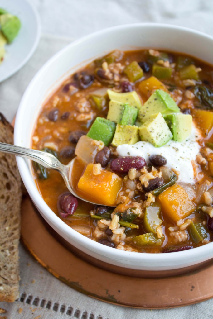 butternut squash turkey chili in a bowl with crusty bread