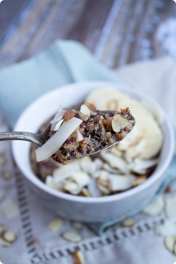 coconut milk porridge on a spoon with a bowl in the background
