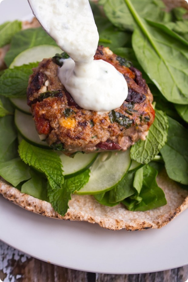 greek lamb burgers 4 ground lamb burgers with sun-dried tomatoes drizzled with yogurt sauce in a pita
