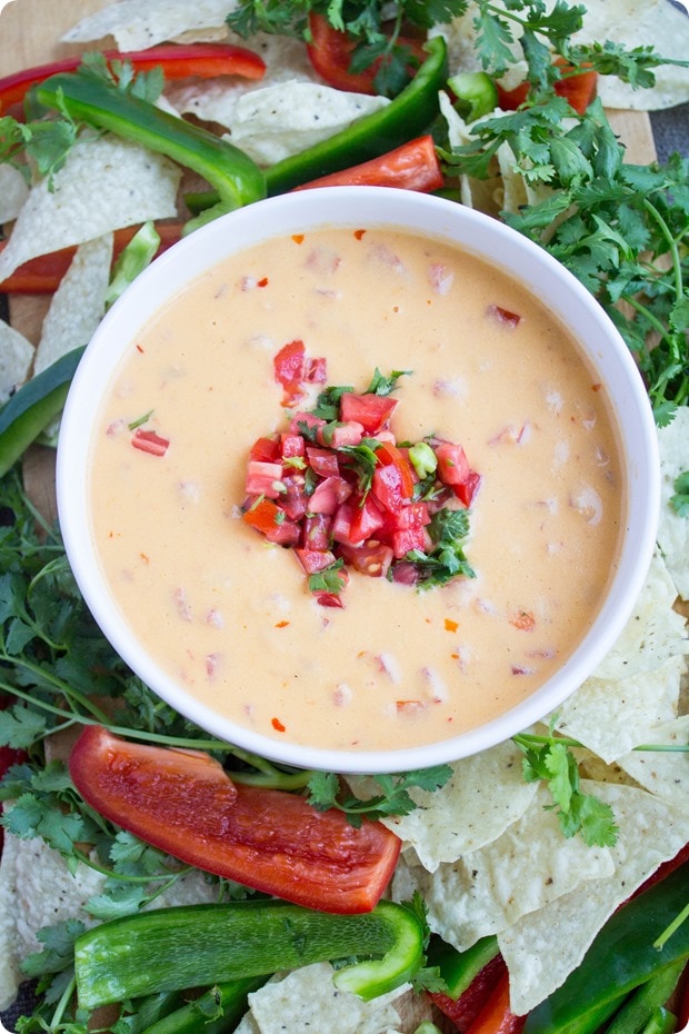 hummus queso healthy tailgating 1 spicy queso dip with diced tomatoes on top, served with bell peppers