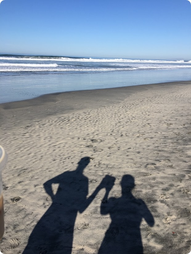walk with coffee on beach san diego