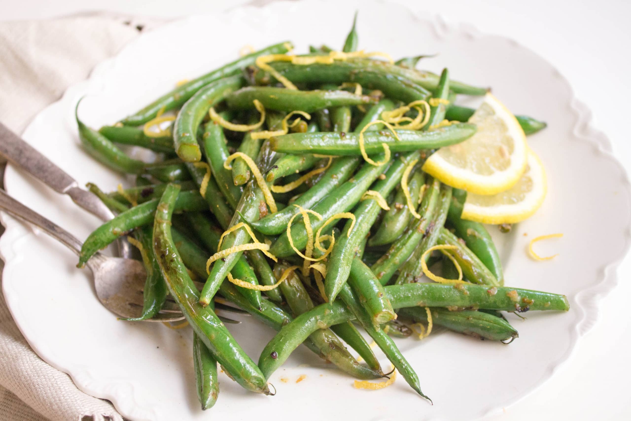 lemon garlic string beans in a shallow white bowl