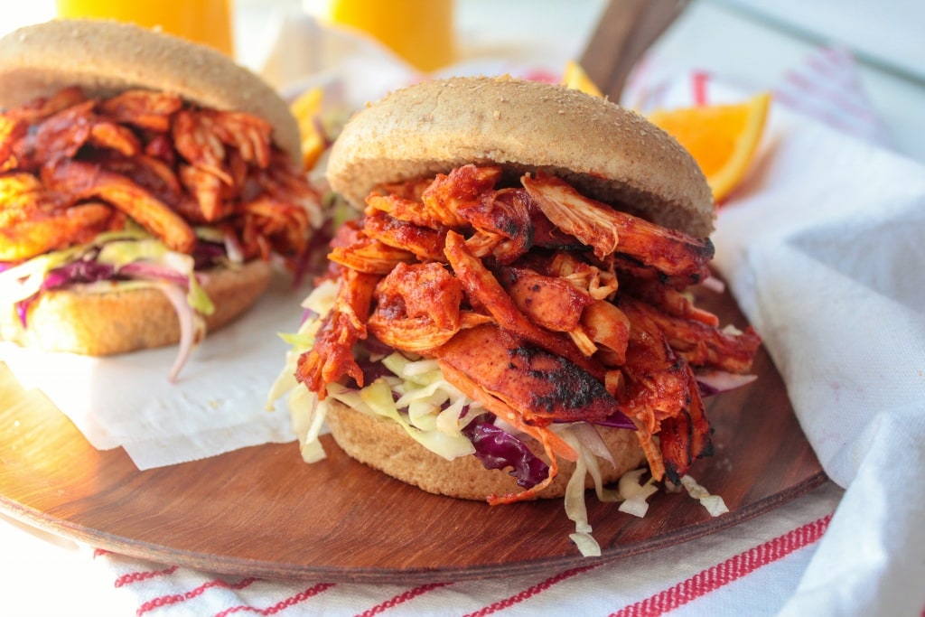 bbq chicken sandwiches on a wooden platter