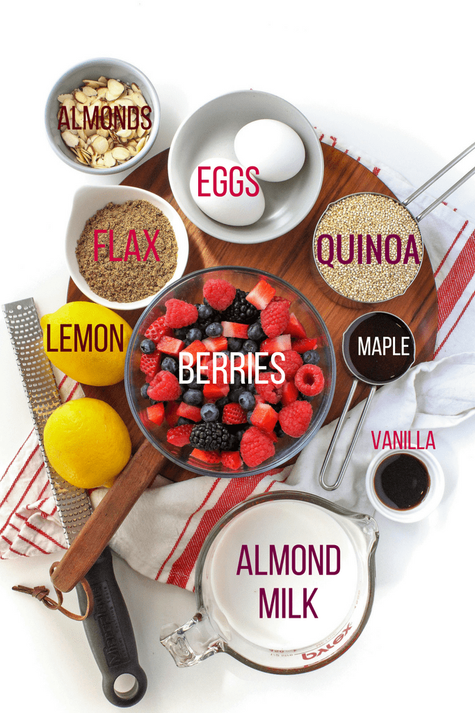 berry quinoa bake ingredients on a wooden platter with a striped kitchen towel