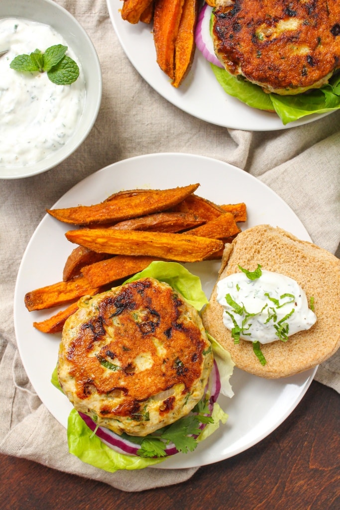 curry turkey burger with yogurt mint sauce on top