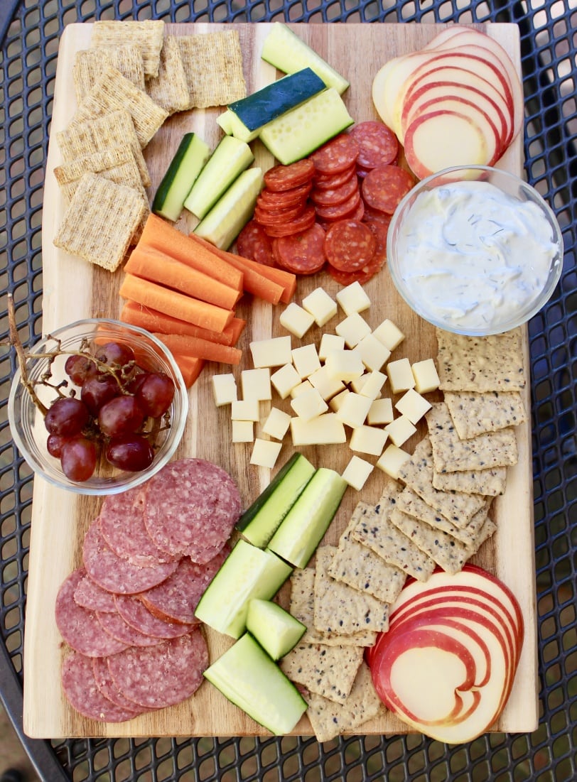 appetizer spread with cured meat cheese veggies crackers fruit