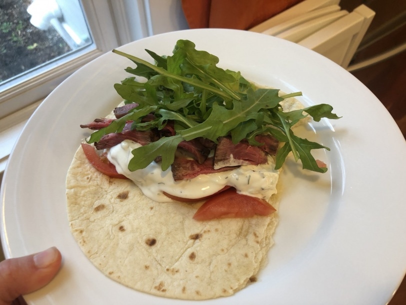 wrap with steak, tzatziki, tomato, arugula