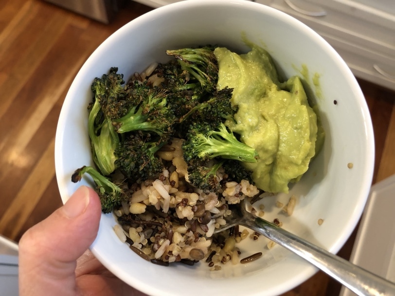 grain bowl with rice, lentils, roasted broccoli, and guacamole