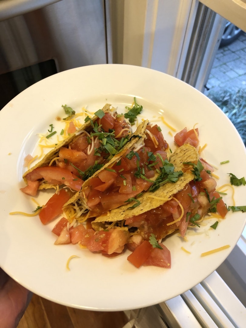 taco night with beef, cheese, tomatoes, cilantro, black beans