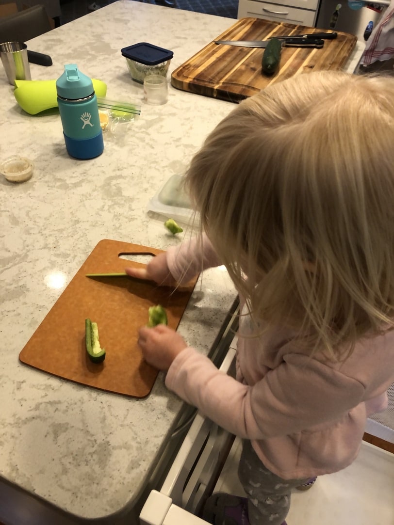toddler helping in the kitchen