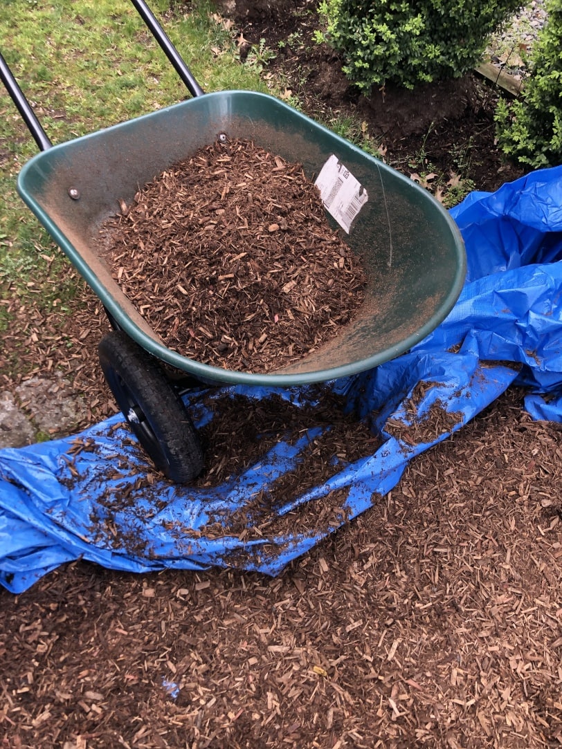 filling outdoor playhouse border with mulch