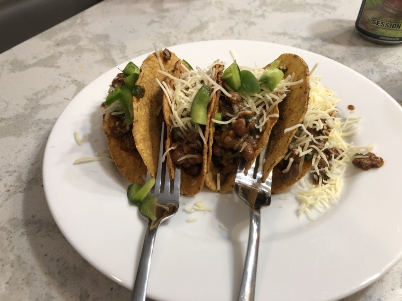 homemade tacos held up by forks