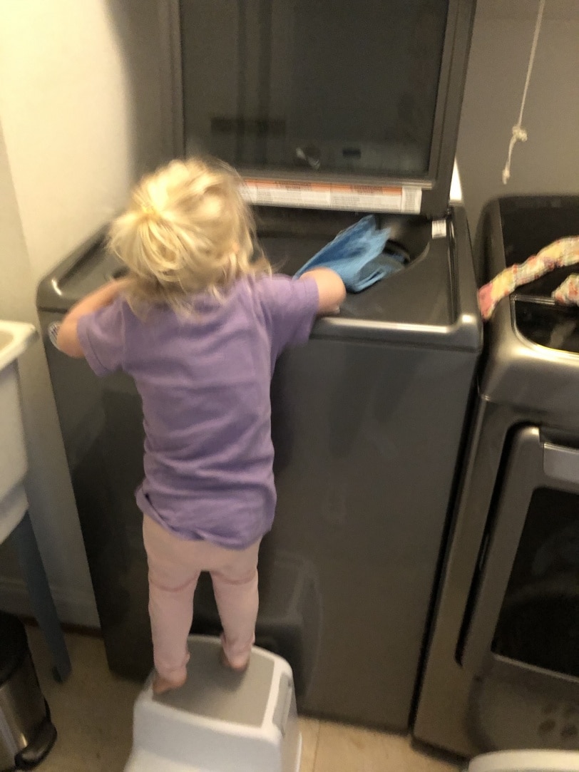toddler helping with laundry
