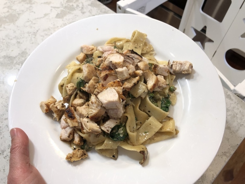 Pappardelle with wilted spinach, sweet peas, and fresh ricotta and chicken