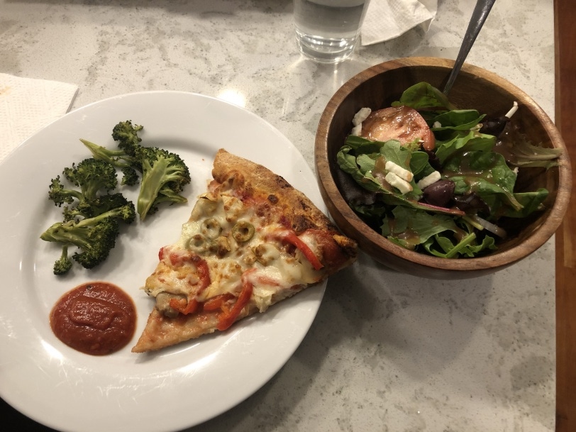 pizza with roasted broccoli and greek salad