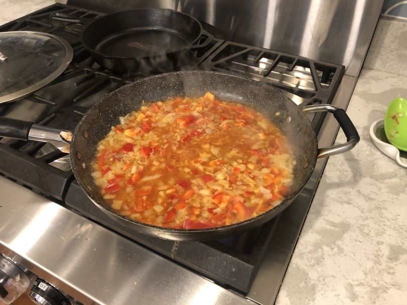 onion and red pepper simmering in pan