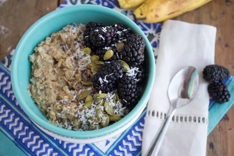 microwave banana oatmeal with blackberries in a blue bowl