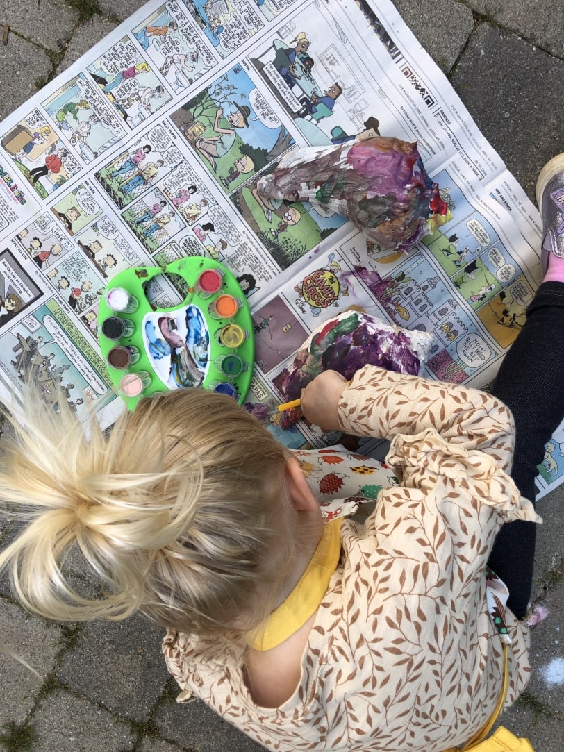 toddler painting a shell with watercolor paint