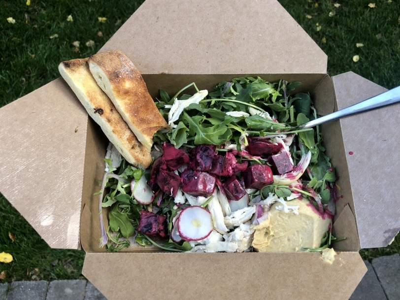arugula salad with beets, radish, cheese, hummus, and bread