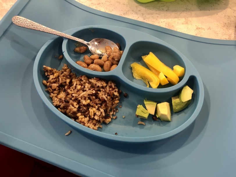 toddler meal of rice, quinoa, beans, yellow bell peppers, and avocado