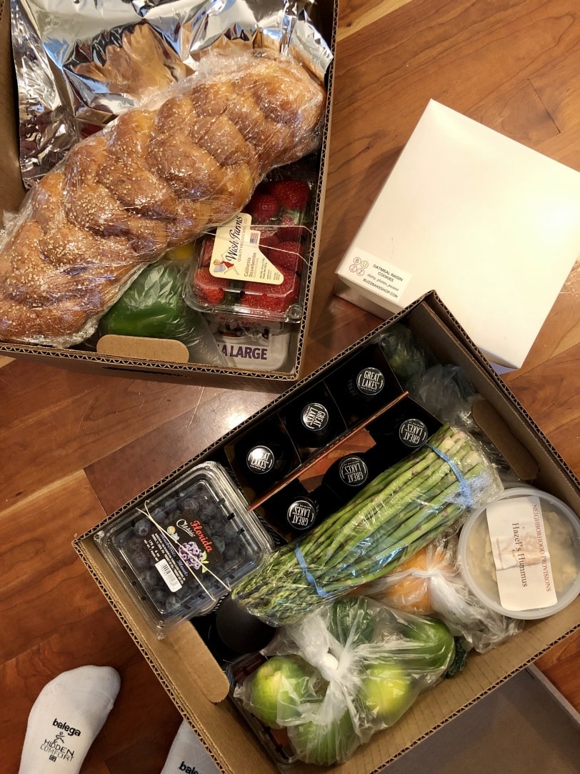 boxes of produce and prepared foods from neighborhood provisions