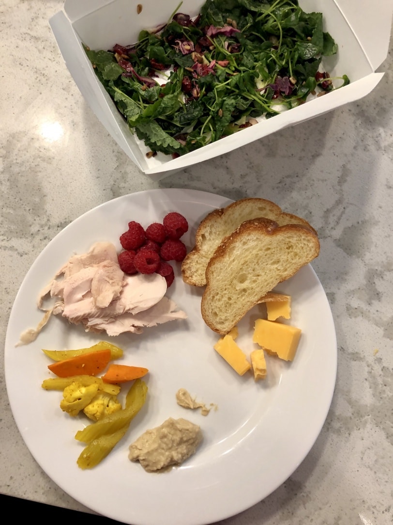 lunch plate with smoked chicken, cheese, pickled veggies, raspberry, bread, and leftover salad