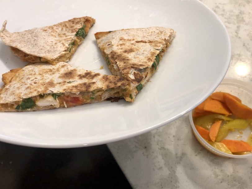cheese tomato and chicken quesadilla with a side of pickled veggies