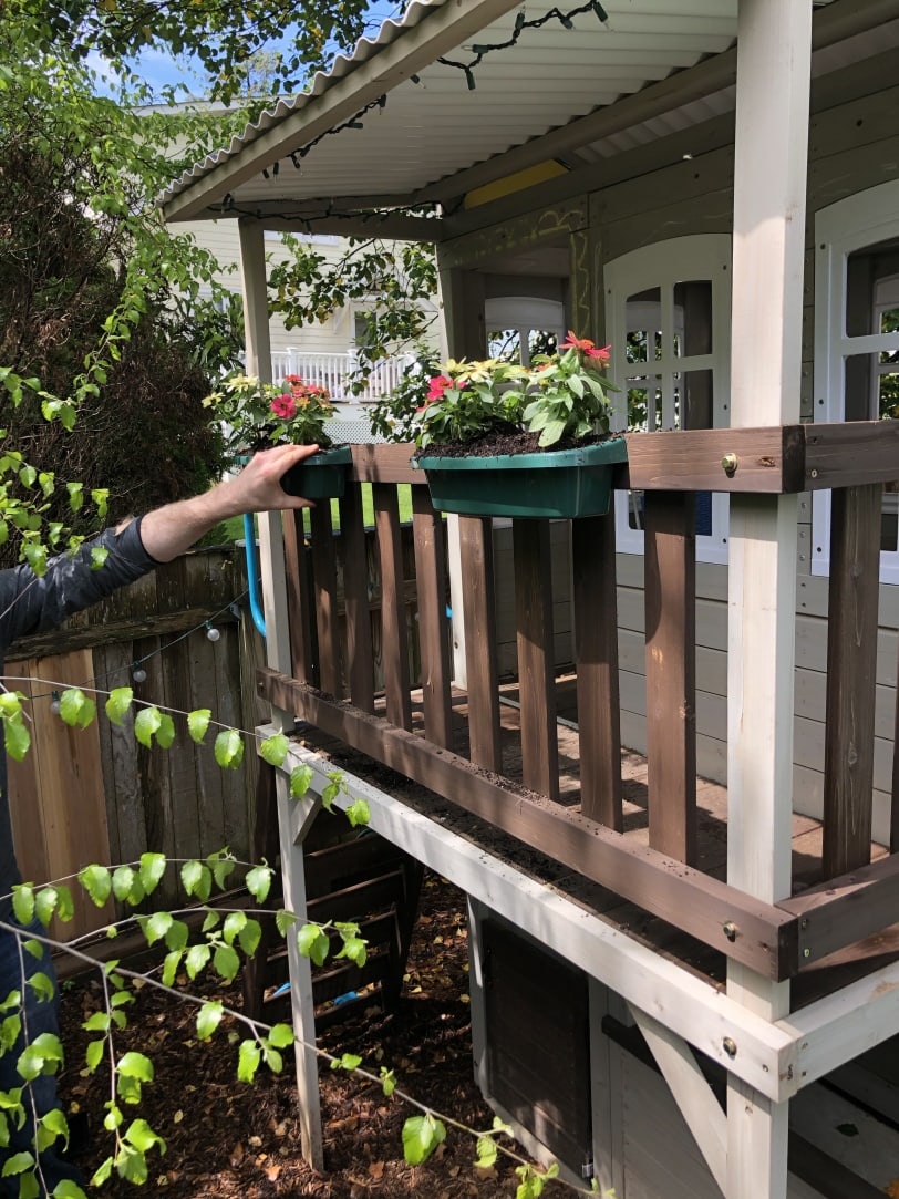 toddler playhouse with flower boxes