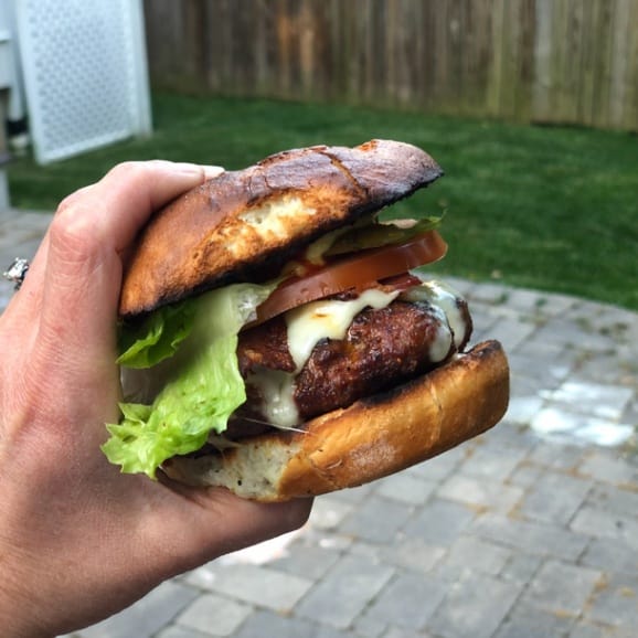 homemade cheeseburger with lettuce tomato bacon and pickle