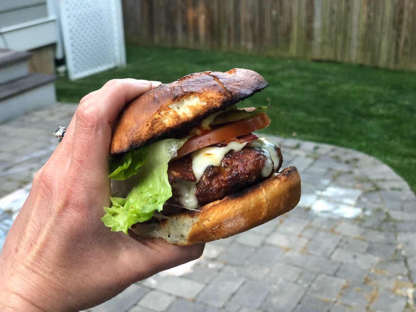 homemade cheeseburger with lettuce tomato bacon and pickle