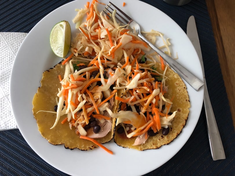 salmon tacos with slaw, black beans, and hot sauce