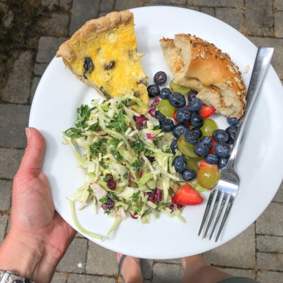 quiche, slaw salad, fruit, and bagel