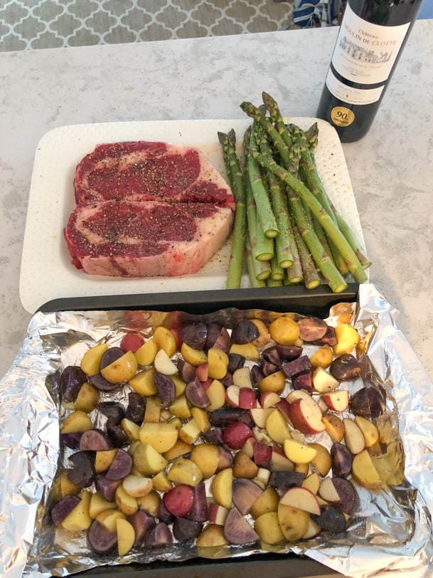 steak, asparagus, and potatoes before cooking