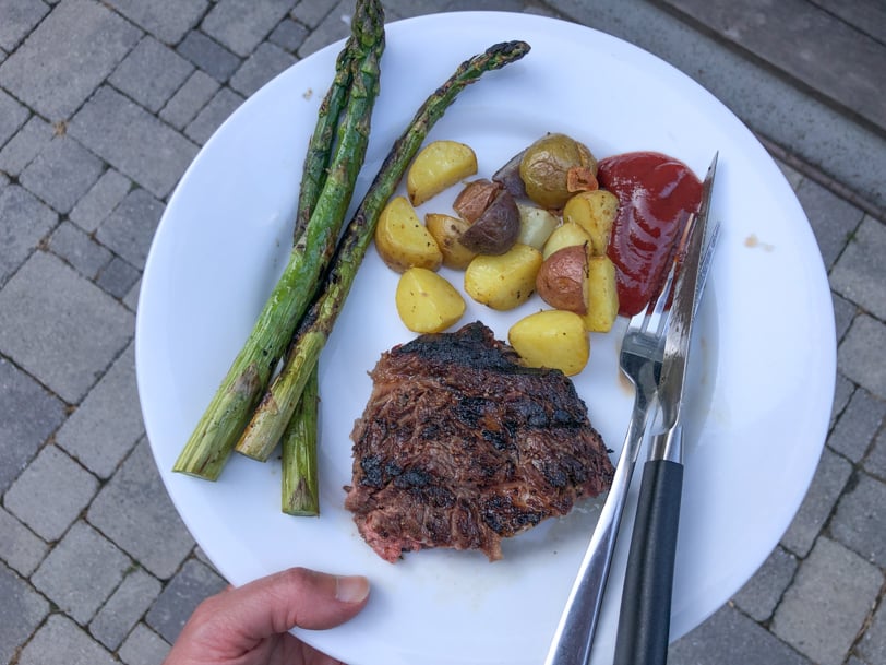 steak, asparagus, and potatoes with ketchup