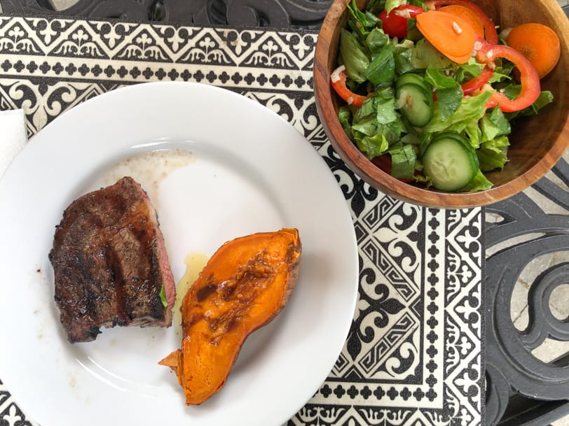 steak, sweet potatoes, and salad