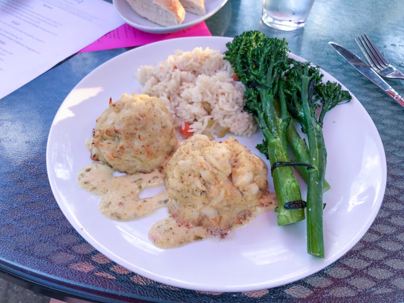 crab cakes, rice, and broccoli rabe from andora restaurant