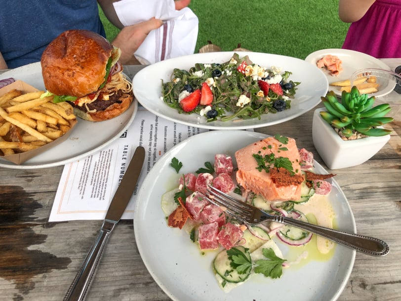 salmon, burger, and fries and salad to share
