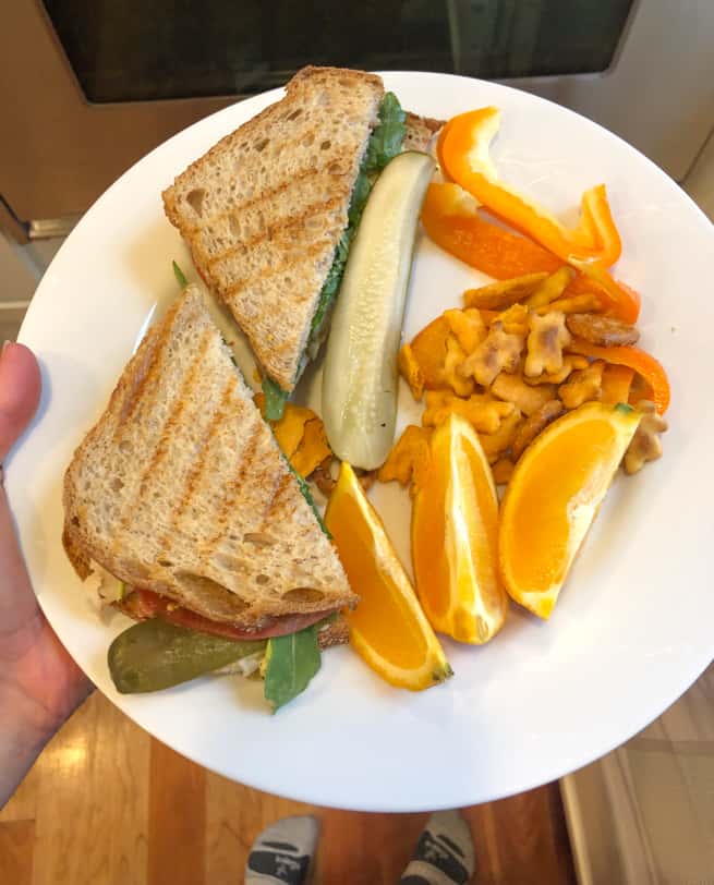 sandwich with an orange peppers and snack mix