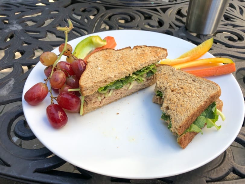 tuna salad sandwich with grapes, carrots, and bell pepper
