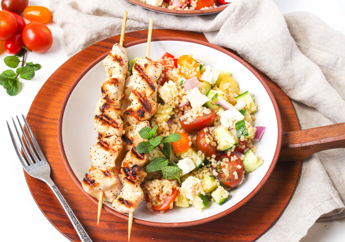 Mediterranean bulgur salad with chicken skewers