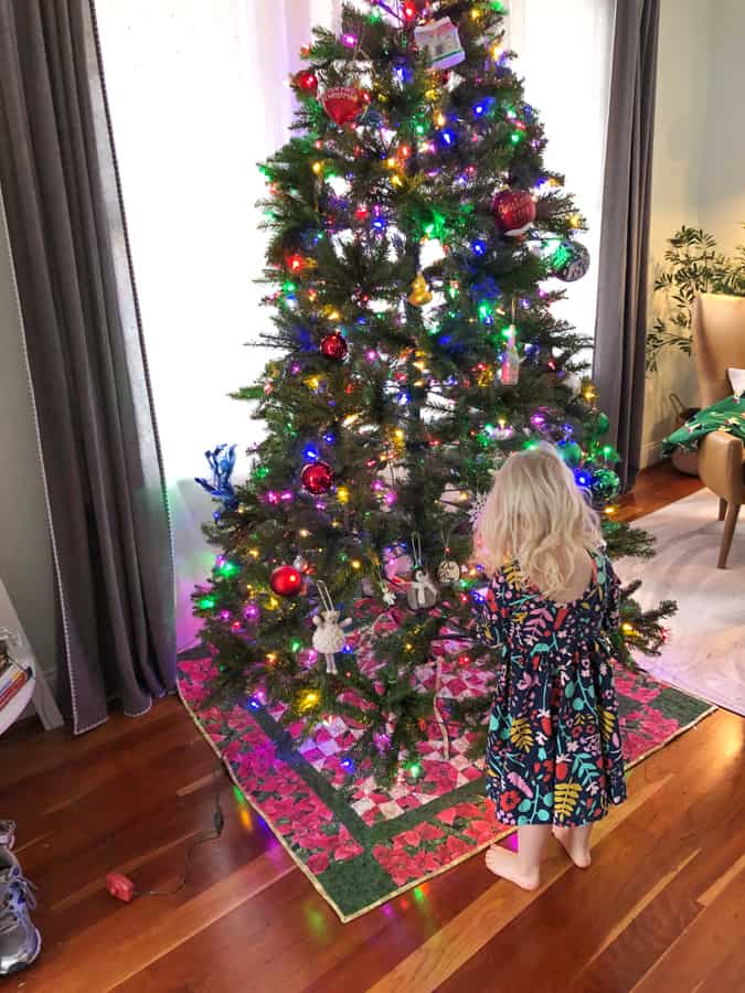 toddler helping decorate christmas tree