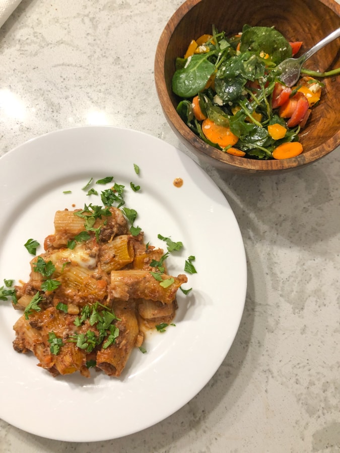 baked rigatoni with lamb ragu and salad
