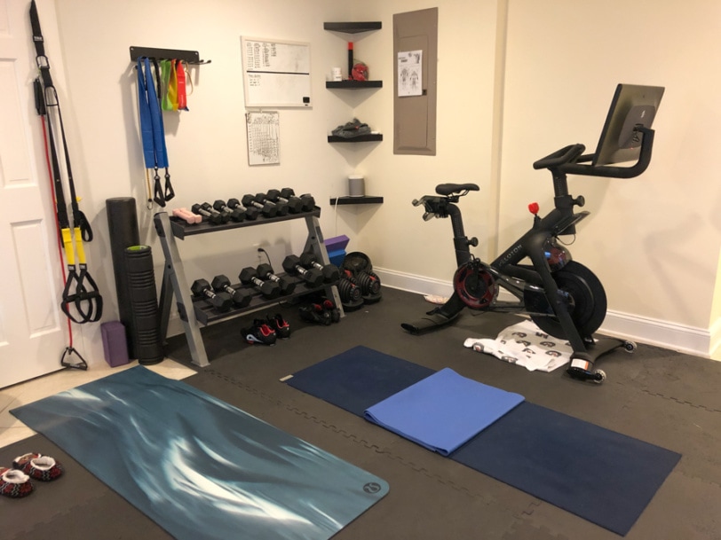 home gym basement set up with peloton and weights