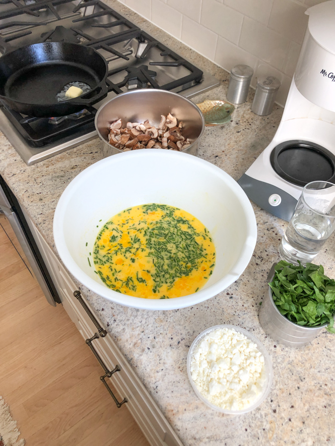 making a goat cheese and mushroom frittata