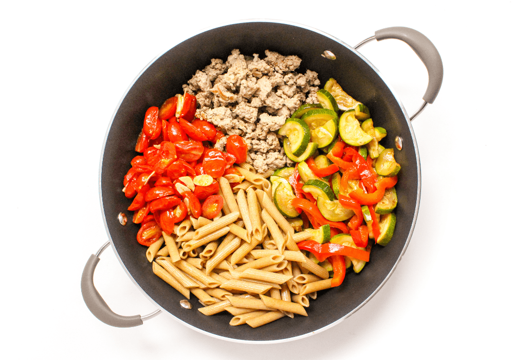 penne pasta ingredients in a large skillet