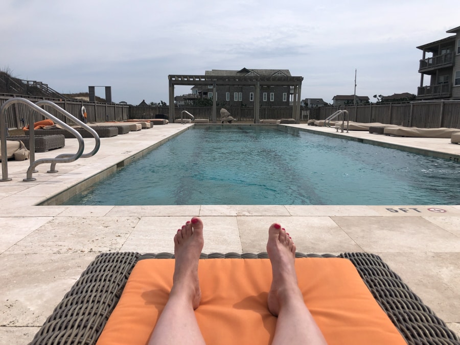 sitting at the pool at the sanderling resort