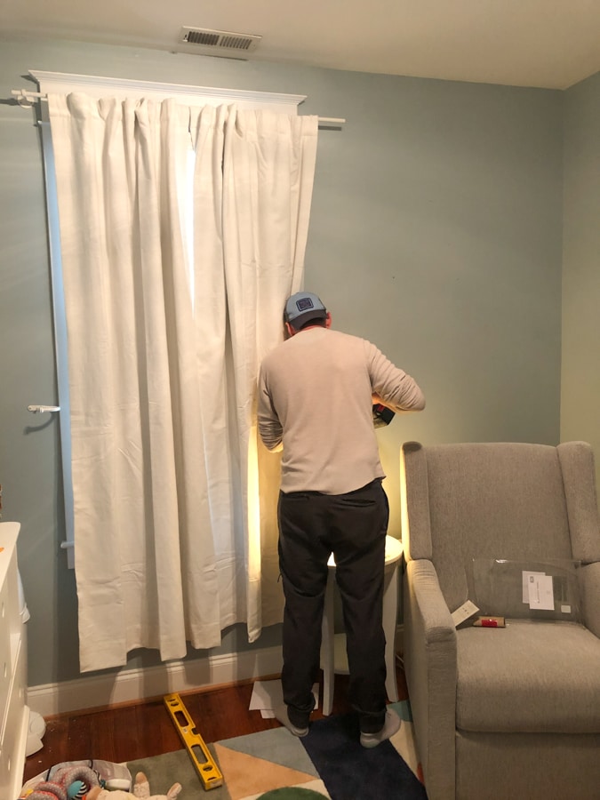 installing blackout curtains in baby's room